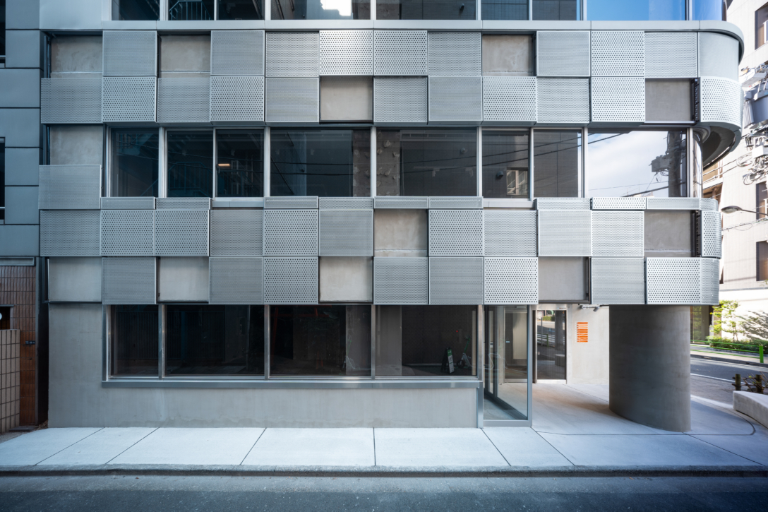 パンチングパネルで覆われた、S-CUBEビルの低層部の外観
